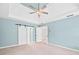 Spacious main bedroom with tray ceilings, ceiling fan, carpeted floor, and open doorway to the bathroom at 5344 Saint Martins Se Ct, Mableton, GA 30126