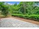 Backyard patio features stone pavers bordered by mulch and trimmed hedges at 5344 Saint Martins Se Ct, Mableton, GA 30126