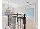 Elegant staircase with an ornate iron railing leading to the second floor with light colored walls at 5344 Saint Martins Se Ct, Mableton, GA 30126