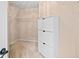 Organized walk-in closet with ample shelving and storage space with additional cabinet at 5344 Saint Martins Se Ct, Mableton, GA 30126