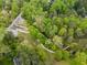 Overhead shot of the property with a creek, walking trails, and bridge surrounded by lush trees at 115 Peachtree Memorial Nw Dr # C1, Atlanta, GA 30309