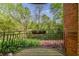View from the balcony of the lush backyard with mature trees and flowering plants at 115 Peachtree Memorial Nw Dr # C1, Atlanta, GA 30309
