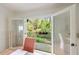 Balcony access from the dining room offers a view of the lush backyard at 115 Peachtree Memorial Nw Dr # C1, Atlanta, GA 30309