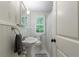 Bathroom features pedestal sink, hexagon tile, and window at 115 Peachtree Memorial Nw Dr # C1, Atlanta, GA 30309