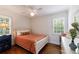 Bedroom with hardwood floors, ceiling fan, two windows, and closet at 115 Peachtree Memorial Nw Dr # C1, Atlanta, GA 30309