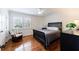 Bedroom with hardwood floors, ceiling fan, neutral color palette, and natural light at 115 Peachtree Memorial Nw Dr # C1, Atlanta, GA 30309