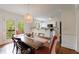 Open dining area with kitchen pass-through and French doors to a peaceful balcony at 115 Peachtree Memorial Nw Dr # C1, Atlanta, GA 30309