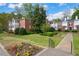 Apartment building with manicured lawn, bushes, and mature trees at 115 Peachtree Memorial Nw Dr # C1, Atlanta, GA 30309
