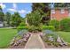 Inviting front entrance with lush landscaping, a bench, and a well-maintained brick building at 115 Peachtree Memorial Nw Dr # C1, Atlanta, GA 30309