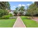 Charming brick apartment building with beautiful landscaping, lush lawn, and lovely walkway at 115 Peachtree Memorial Nw Dr # C1, Atlanta, GA 30309