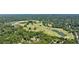 An aerial view of a meticulously designed golf course surrounded by abundant trees and a tranquil lake at 115 Peachtree Memorial Nw Dr # C1, Atlanta, GA 30309