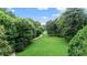 Beautiful view of the property grounds featuring a sprawling green lawn, walking path, and mature trees at 115 Peachtree Memorial Nw Dr # C1, Atlanta, GA 30309