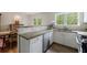 Well-lit kitchen featuring granite countertops, stainless appliances, and custom cabinetry at 115 Peachtree Memorial Nw Dr # C1, Atlanta, GA 30309
