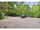 Outdoor parking lot surrounded by mature trees at 115 Peachtree Memorial Nw Dr # C1, Atlanta, GA 30309