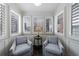 Cozy sunroom with shuttered windows, comfortable chairs, and neutral decor creating a relaxing space at 115 Peachtree Memorial Nw Dr # C1, Atlanta, GA 30309