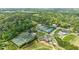 An aerial view showcasing multiple well-maintained tennis courts with a clubhouse amidst a lush green landscape at 115 Peachtree Memorial Nw Dr # C1, Atlanta, GA 30309