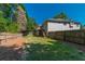 Sprawling fenced backyard with lush lawn and mature trees, perfect for outdoor enjoyment at 135 Greenmont Downs Trce, Alpharetta, GA 30009