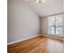 Bright bedroom with hardwood floors, neutral paint, a large window, and ample closet space at 135 Greenmont Downs Trce, Alpharetta, GA 30009