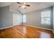 Serene bedroom featuring hardwood floors, neutral walls, high ceiling, and natural light from windows at 135 Greenmont Downs Trce, Alpharetta, GA 30009