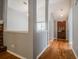 Inviting entryway with wood floors leading to an open living space, enhanced by neutral gray walls at 135 Greenmont Downs Trce, Alpharetta, GA 30009