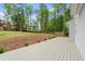 Expansive backyard with a deck, lawn area, and mature trees create a private outdoor oasis at 3070 Branford Ct, Marietta, GA 30062