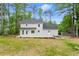 Expansive backyard showcasing a light gray home, a deck, and lush greenery at 3070 Branford Ct, Marietta, GA 30062
