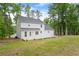 Large backyard featuring a light gray house and a deck surrounded by mature trees at 3070 Branford Ct, Marietta, GA 30062