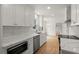 Updated kitchen showcases white cabinetry, modern stainless appliances, stone countertops, and sleek tile backsplash at 3070 Branford Ct, Marietta, GA 30062