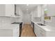 Bright kitchen features white cabinets, stainless steel appliances, light countertops, and hardwood floors at 3070 Branford Ct, Marietta, GA 30062