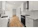 Open kitchen with bright white cabinets, stainless steel appliances, and modern countertops for a sleek design at 3070 Branford Ct, Marietta, GA 30062