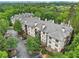 Apartment complex featuring a well-maintained exterior with parking and green spaces from an aerial perspective at 5559 Glenridge Dr # 1103, Sandy Springs, GA 30342