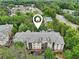 Aerial shot of apartment buildings surrounded by mature trees, showcasing community layout and location at 5559 Glenridge Dr # 1103, Sandy Springs, GA 30342