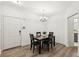 Bright dining room with modern floors, chandelier lighting, and access to a nearby bathroom at 5559 Glenridge Dr # 1103, Sandy Springs, GA 30342