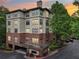 Multi-story apartment building with a mix of brick and stucco facade, showcasing balconies and ample parking at 5559 Glenridge Dr # 1103, Sandy Springs, GA 30342