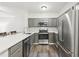 Charming kitchen with stainless steel appliances, white quartz countertops and grey cabinets at 5559 Glenridge Dr # 1103, Sandy Springs, GA 30342