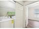 Convenient laundry area with washer, dryer, shelving and easy access to a bedroom at 5559 Glenridge Dr # 1103, Sandy Springs, GA 30342