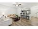 Open-concept living area featuring wood floors, comfortable seating, and a breakfast bar, blending style and function at 5559 Glenridge Dr # 1103, Sandy Springs, GA 30342