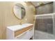 Modern bathroom featuring a round mirror, wooden accents, and sleek walk-in shower at 71 Ramey Rd, Sugar Hill, GA 30518