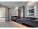 Bright bathroom featuring double vanity with black marble countertop and rectangular sinks at 71 Ramey Rd, Sugar Hill, GA 30518
