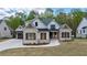 Charming two-story home with stone accents, dark shutters, and well-manicured landscaping at 71 Ramey Rd, Sugar Hill, GA 30518