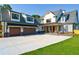 Stunning two-story home boasting a spacious driveway, two-car garage, and manicured lawn at 71 Ramey Rd, Sugar Hill, GA 30518