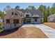 Beautiful home exterior featuring stone accents, gabled roof, and well-manicured landscaping at 71 Ramey Rd, Sugar Hill, GA 30518