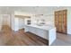 Bright, modern kitchen with a large island, stainless steel appliances, and hardwood floors at 71 Ramey Rd, Sugar Hill, GA 30518