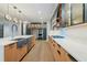Modern kitchen with stainless steel appliances, a large island, custom cabinetry, and beautiful pendant lighting at 71 Ramey Rd, Sugar Hill, GA 30518