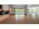 Bright living room featuring a stone fireplace, hardwood floors, and screened porch access at 71 Ramey Rd, Sugar Hill, GA 30518