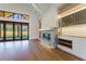 Bright living room with hardwood floors, fireplace, and access to backyard through large glass doors at 71 Ramey Rd, Sugar Hill, GA 30518
