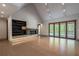 Modern living room with a stone fireplace, built-in shelves, and access to screened porch at 71 Ramey Rd, Sugar Hill, GA 30518