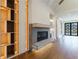 Open-concept living room with fireplace, hardwood floors, and custom built-ins with accent lighting at 71 Ramey Rd, Sugar Hill, GA 30518