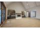 Bright and airy living room with vaulted ceilings, a stone fireplace, custom built-ins, and access to the outdoor patio at 71 Ramey Rd, Sugar Hill, GA 30518