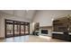 Open-concept living room featuring a fireplace, custom built-ins, and folding patio doors leading to outdoor living at 71 Ramey Rd, Sugar Hill, GA 30518